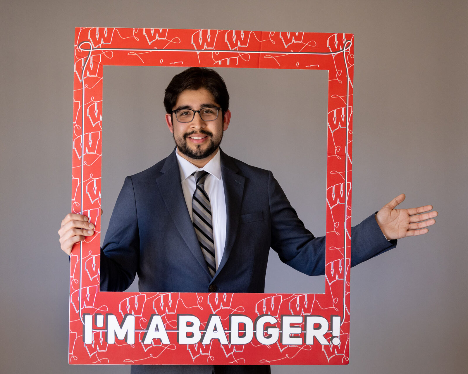 Returning adult student with frame that reads "I'm a Badger."