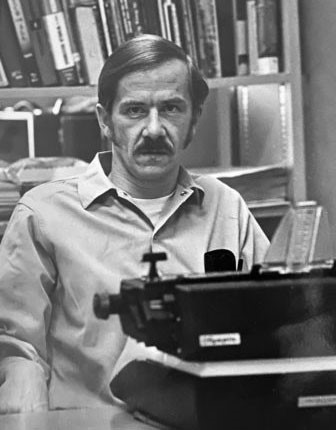 Roger Bruesewitz sitting at a typewriter.