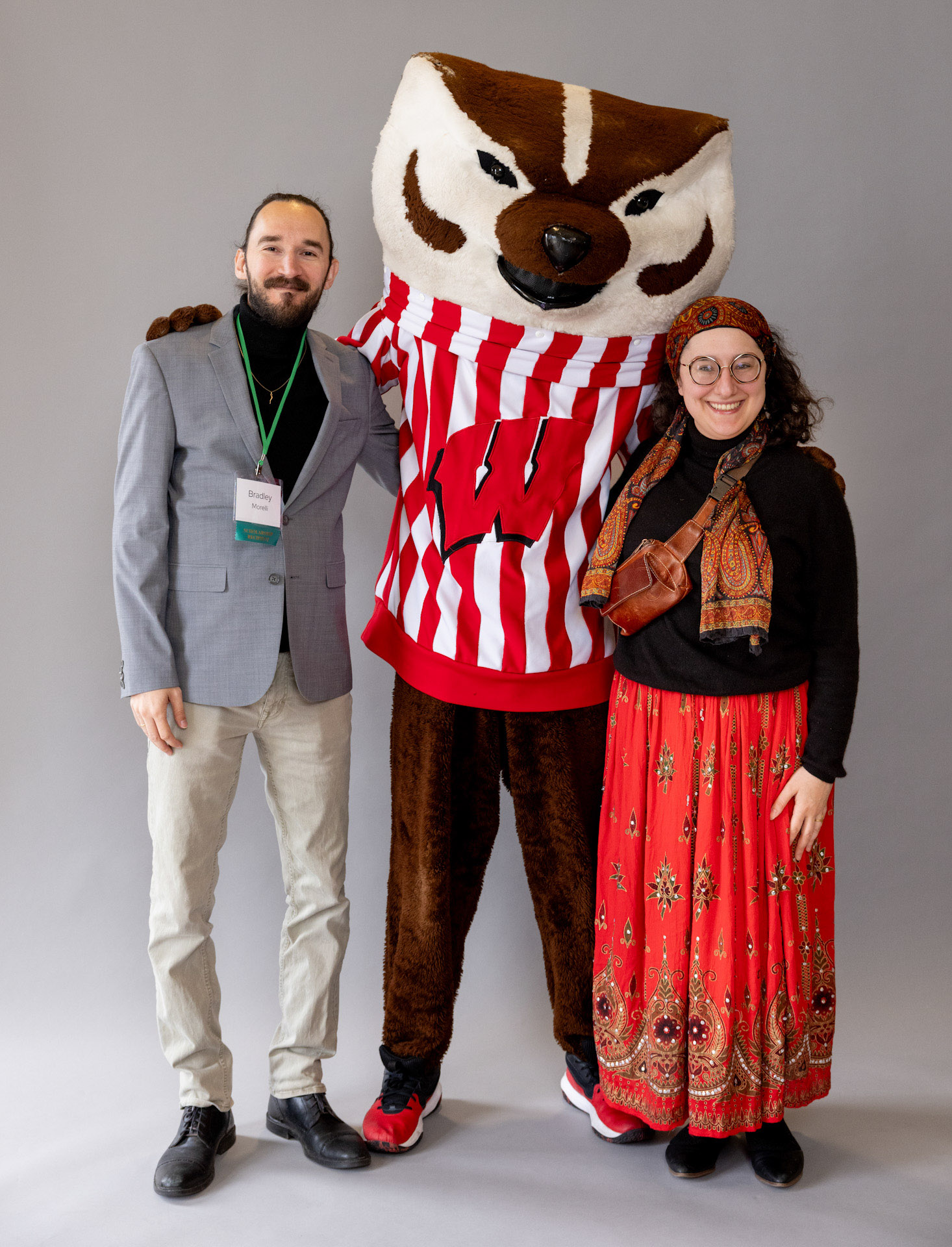 Returning adult student and guest with Bucky Badger.