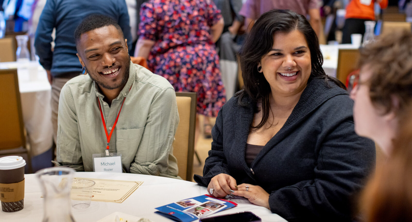 Returning adult student sitting at a table with a guest.